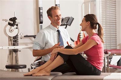 A physical therapist working with a patient